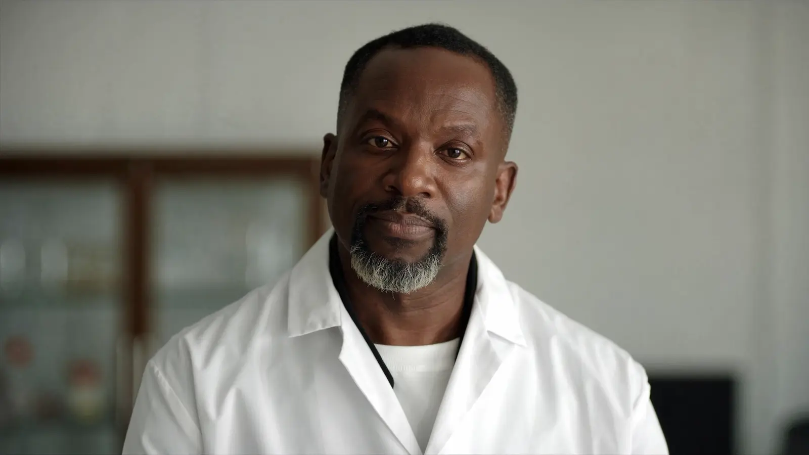Dr. Kwame Asante, PhD, at a biomedical research facility after years of UK-based study in men’s wellness, natural product pharmacology, and herbal formulation research